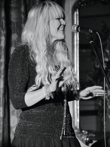 Stella Newman singing at a gig